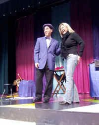 Comedy Magician Jersey Jim with adult helper on stage