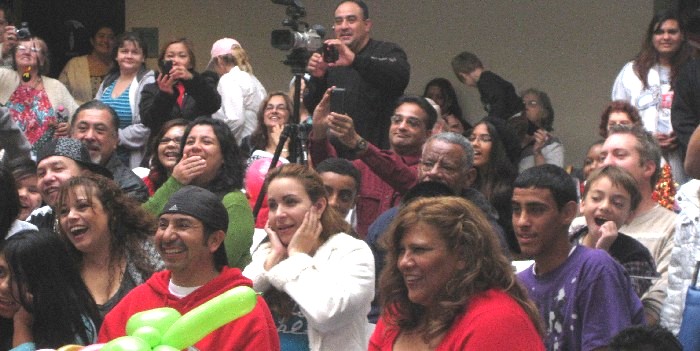 adults laughing at Jersey Jim's stage show